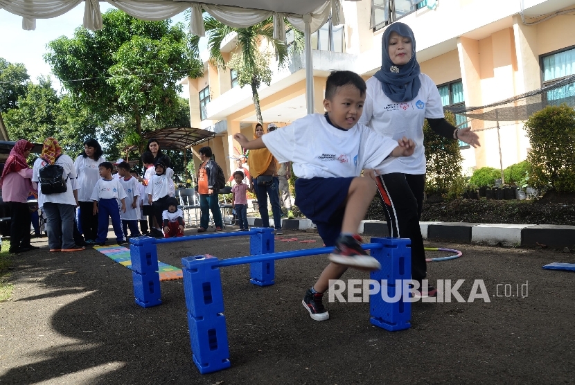  Anak-anak penyandang down syndrome bermain lompat rintangan saat memperingati Hari Down Syndrome Sedunia di Sekolah Luar Biasa (SLB) Pembina Tingkat Nasional, Jakarta, Kamis (30/3). 