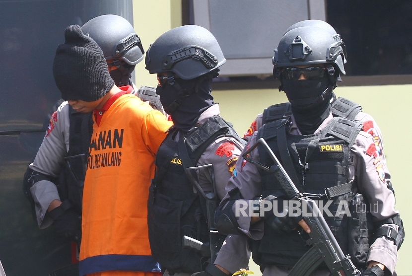 Anggota Brimob bersenjata lengkap menggiring salah satu dari dua tersangka teroris (ilustrasi)