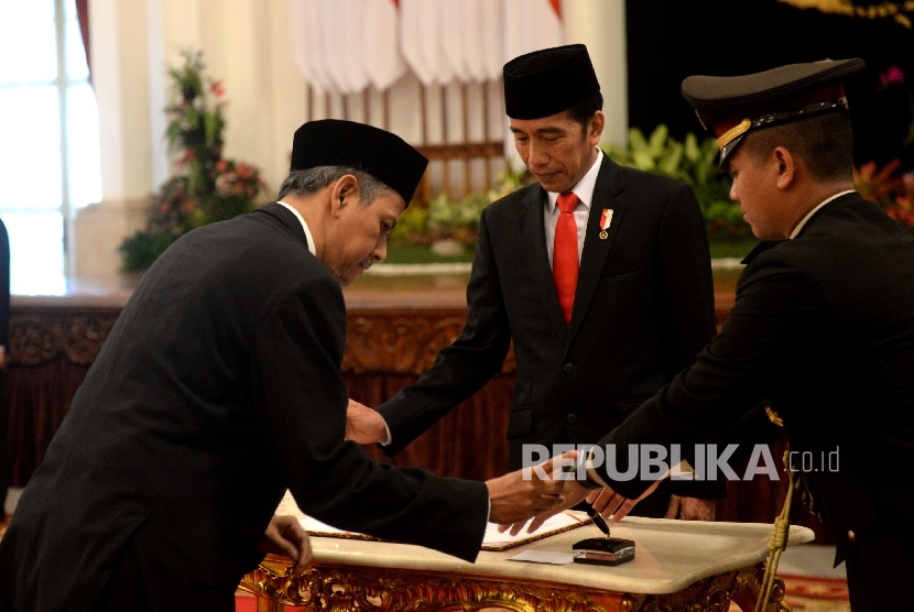 President Joko Widodo witnessess the signing of inauguration report by member of Supervisory Council of Implementing Body of Hajj Administration Management Body (BPKH), Anggito Abimanyu, at the State Palace, on Wednesday (July 26).