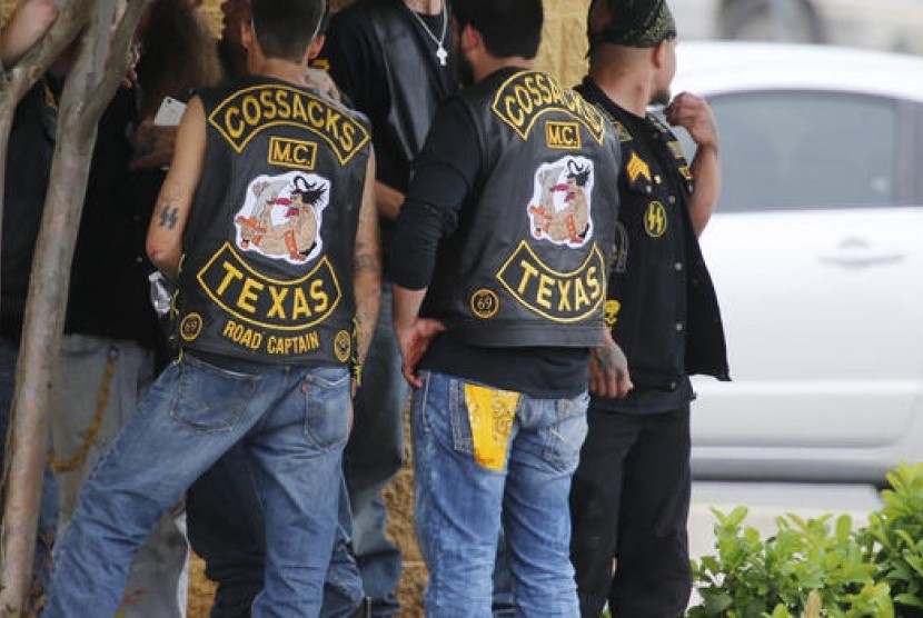 Anggota geng motor berkumpul saat pihak berwenang menyelidiki perkelahian di restoran Twin Peaks di Waco, Texas, AS, Ahad (17/5).