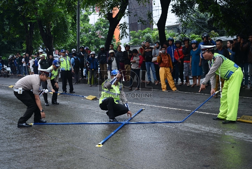 Anggota kepolisian laka lantas Polri bersama anggota kepolisian Polres Metro Jakarta Selatan melakukan olah TKP kasus tabrakan outlander yang menewaskan 4 orang di Arteri Pondok Indah, Jakarta Selatan, Kamis (22/1).(Republika/Raisan Al Farisi)