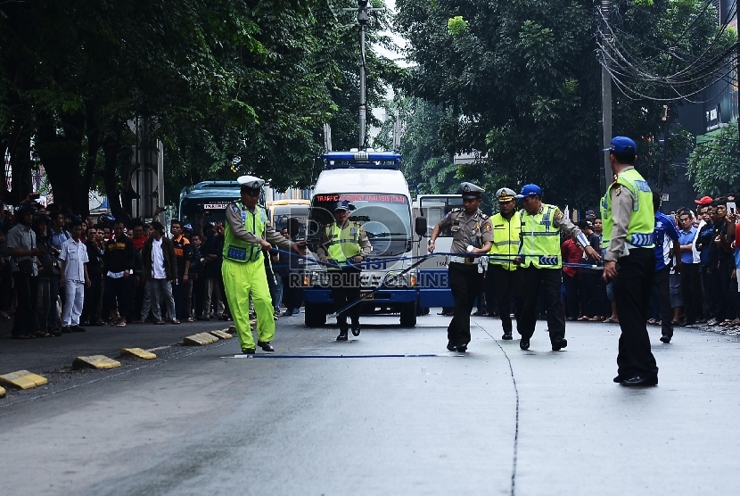 Anggota kepolisian laka lantas Polri bersama anggota kepolisian Polres Metro Jakarta Selatan melakukan olah TKP kasus tabrakan outlander yang menewaskan 4 orang di Arteri Pondok Indah, Jakarta Selatan, Kamis (22/1).(Republika/Raisan Al Farisi)