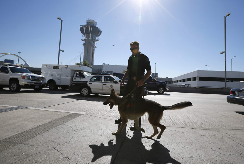  Anggota polisi berpatroli di luar Terminal 3 setelah insiden penembakan di Bandara Los Angeles (LAX), California, Jumat (1/11) waktu setempat.  (REUTERS/Lucy Nicholson)