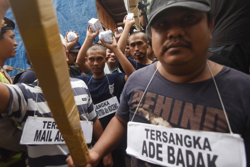 Anggota Polres Metro Jakarta Timur menggelar rekonstruksi penggerebekan bandar narkoba yang menewaskan seorang anggota polisi dan informannya di Kawasan Berlan, Jakarta, Jumat (19/2). (Antara/Akbar Nugroho Gumay)