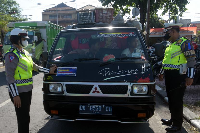 Anggota Satlantas Polresta Denpasar menegur pengemudi mobil saat Operasi Patuh Agung 2022 di Denpasar, Bali, Rabu (15/6/2022). Kebijakan ganjil genap pelat kendaraan bermotor akan diberlakukan di Bali selama perhelatan Konferensi Tingkat Tinggi (KTT) G20.