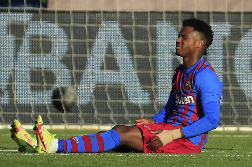 Ansu Fati dari Barcelona, duduk karena cedera saat pertandingan sepak bola La Liga Spanyol antara Celta dan Barcelona di stadion Balaidos di Vigo, Spanyol, Sabtu, 6 November 2021.