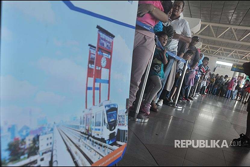 Antrean warga untuk menaiki Kereta api ringan atau Light Rail Transit (LRT) di depan tangga Skybridge stasiun LRT Bandara Sultan Mahmud Badaruddin (SMB) Palembang,Sumsel, Minggu(26/8). 