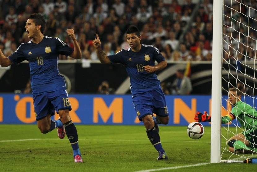 Argentina's Erik Lamela reacts next to team mate Sergio Aguero (R) after Aguero scored a goal against Germany's goalkeeper Manuel Neuer (R) during their friendly soccer match in Duesseldorf September 3, 2014.