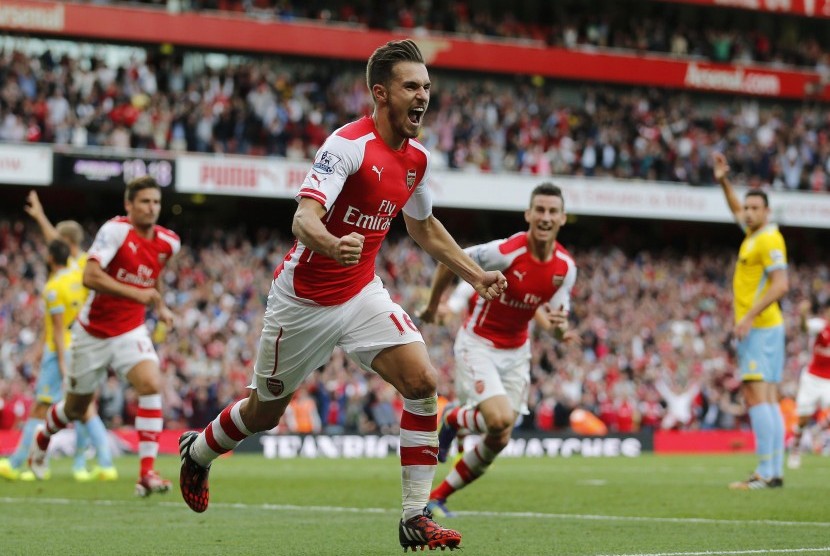 Arsenal's Aaron Ramsey celebrates after scoring a goal against Crystal Palace during the English Premier League soccer match at the Emirates stadium in London August 16, 2014