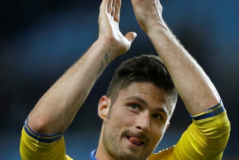 Arsenal's Oliver Giroud applauds the fans after the end of the English Premier League soccer match between Aston Villa and Arsenal at Villa Park stadium in Birmingham, England, Monday, Jan. 13, 2014. Arsenal won the match 2-1.