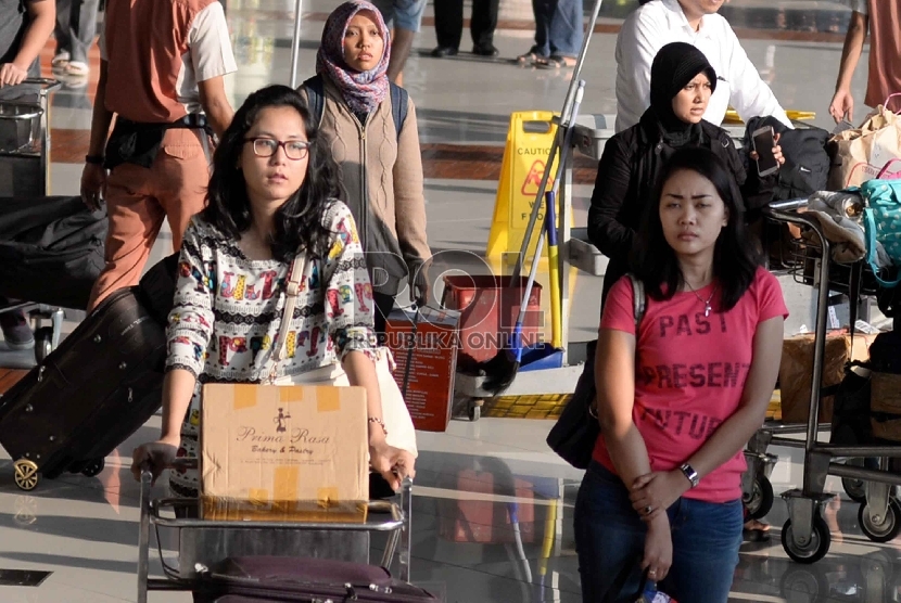 Arus Balik Bandara Soetta: Penumpang menunggu barang bawaan mereka di terminal kedatangan 1C Bandara Internasional Soekarno Hatta, Tangerang, Banten, Rabu (22/7).