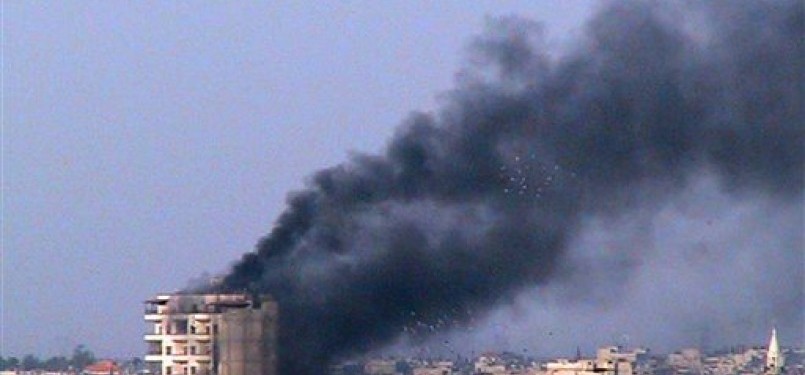 Asap mengepul dari sebuah gedung setelah tentara Suria membakar Kota Horms, basis Persatuan Revolusia Suriah, di Jeb al-Jandali, Provinsi Homs, Suriah tengah. 