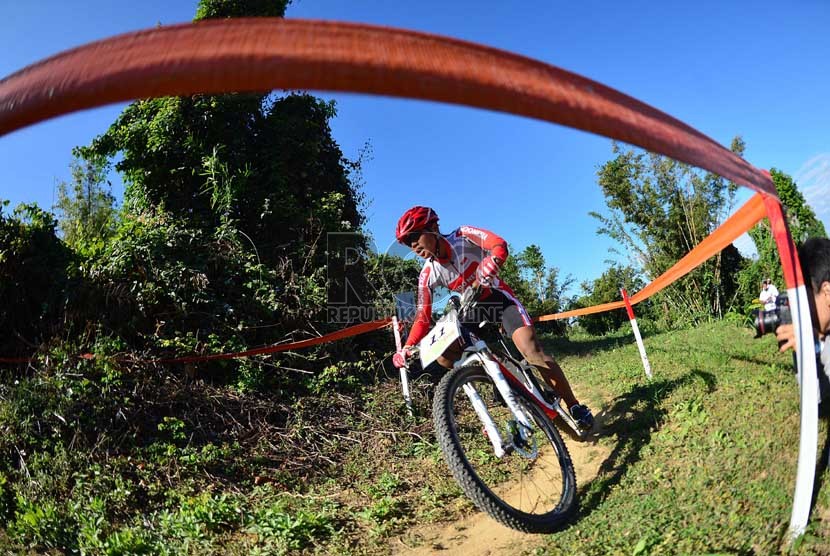 Atlet balap sepeda Indonesia Kusmawati Yasid berlaga pada pertandingan tim estafet cross country di lintasan balap Mount Pleasant Naypyitaw, Myanmar, Kamis (12/12). (Republika/Edwin Dwi Putranto)