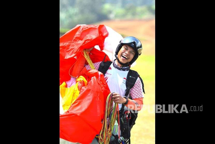 Atlet paralayang putra Indonesia Hening Paradigma, selesai melakukan pendaratan pada babak keenam nomor ketepatan mendarat, Asian Games 2018 di cisarua, Bogor, Jawa Barat, Rabu (22/8). 