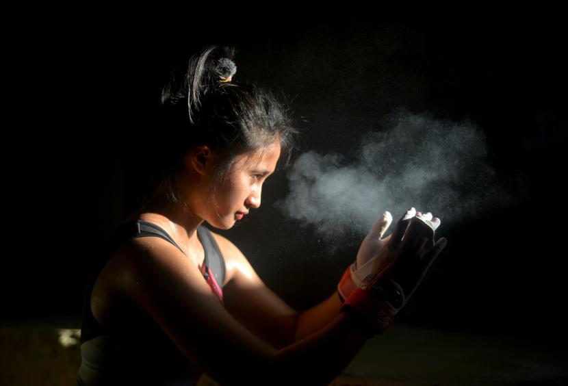 Atlet senam artistik, Regina Ananda Zulda menggunakan bubuk magnesium di tangannya sebelum berlatih di gedung senam Indarung, Padang, Sumatera Barat, Kamis (19/4/2021). Tim senam artistik Sumbar menyiapkan enam atletnya dan memusatkan latihan intensif menjelang PON XX/2020 di Papua.