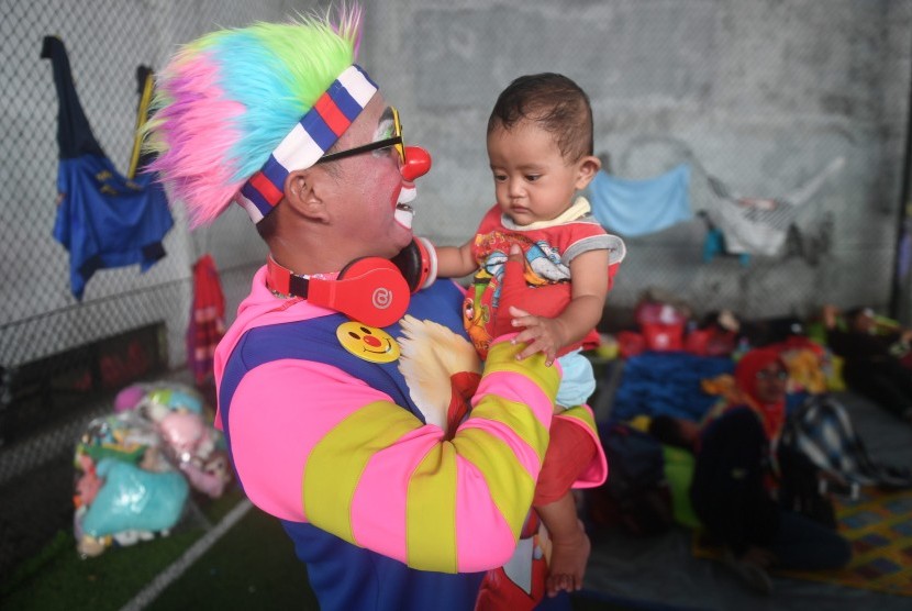 Badut dari Aku Badut Indonesia menghibur anak korban bencana tsunami di pengungsian Labuan, Pandeglang, Banten, Kamis (27/12/2018).