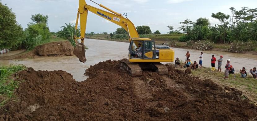 Balai Besar Wilayah Sungai (BBWS) Cimanuk-Cisanggarung mendatangkan alat berat untuk memperbaiki tanggul Sungai Cipanas yang jebol di Kecamatan Losarang, Kabupaten Indramayu, Jumat (12/2/2021). 