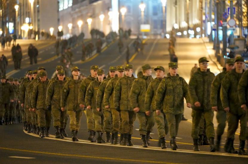 Barisan pasukan Angkatan Darat Rusia yang akan berpartisipasi dalam parade berjalan di sepanjang jalan untuk menghadiri latihan parade militer Hari Kemenangan di Lapangan Merah, di Moskow, Rusia, Senin, 25 April 2022.