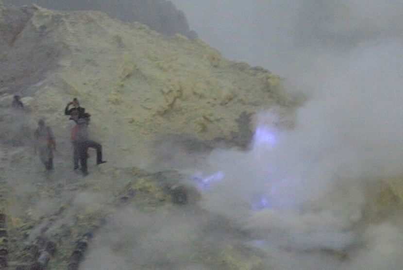 Beberapa wisatawan berusaha mendekat untuk mengambil gambar fenomena alam Blue Fire di dasar kawah Ijen di Banyuwangi, Jawa Timur, Jumat (20/5).