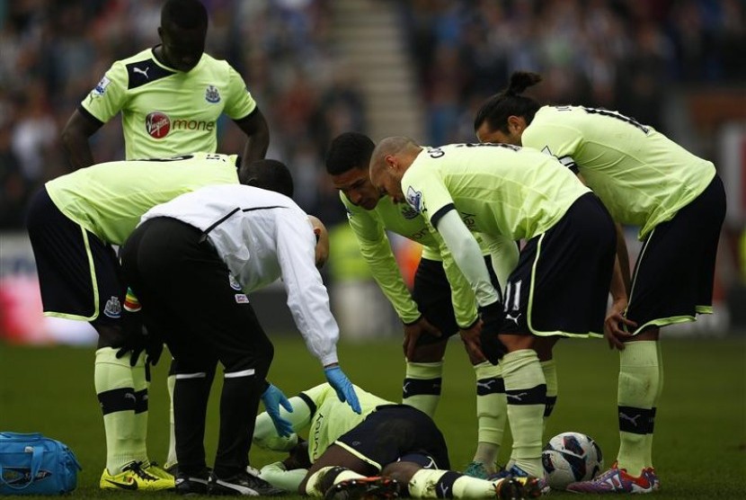 Bek Newcastle Massadio Haidara tergeletak di lapangan usai mendapatkan tekel dari gelandang Wigan Callum McManaman pada laga yang berlangsung, Ahad (18/3) malam di DW Stadium.