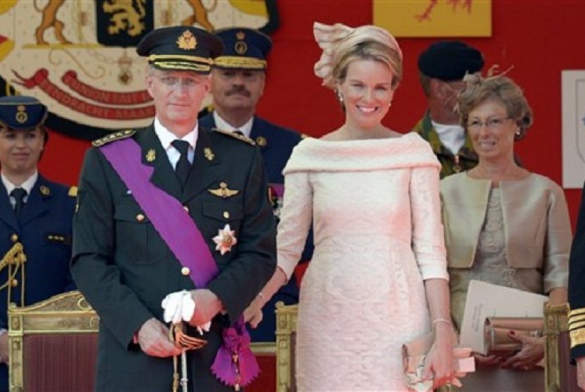 Belgium's King Philippe (second left) and Queen Mathilde review the troops during a military parade in Brussels on Sunday, July 21, 2013. 