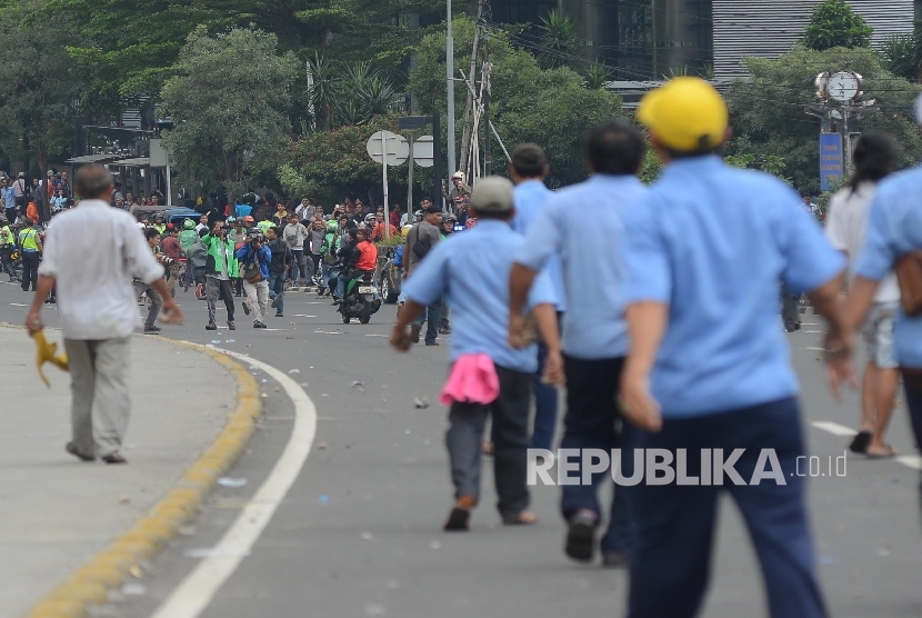 Bentrokan terjadi antara Go-jek dengan supir taxi yang tengah melakukan aksi menutup jalan di Jalan MH.Thamrin, Jakarta Pusat, Selasa (22/3).(Republika/Raisan Al Farisi)