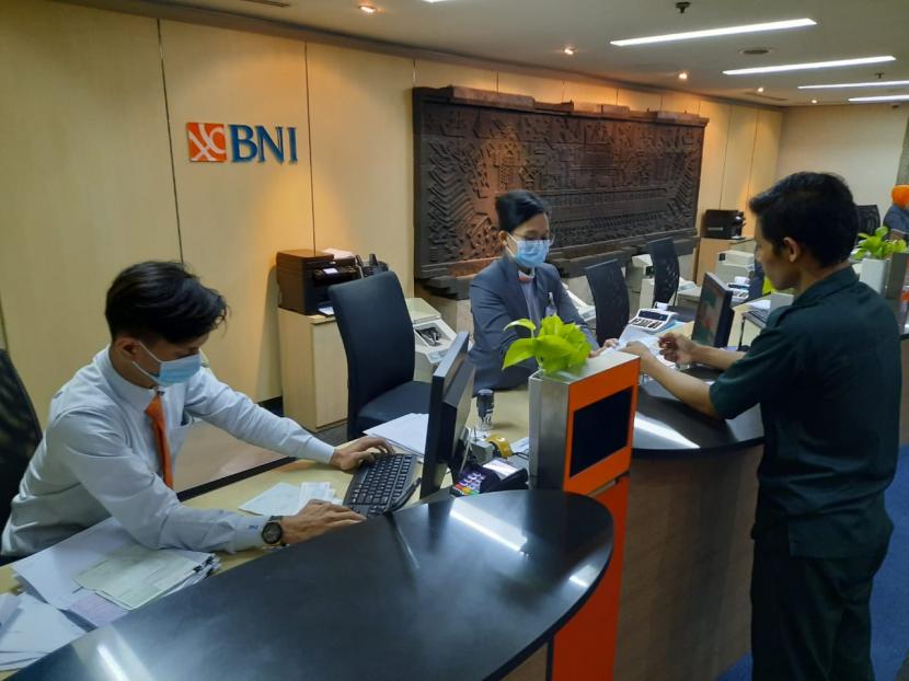 Petugas teller bank BNI melayanai nasabah. ilustrasi 