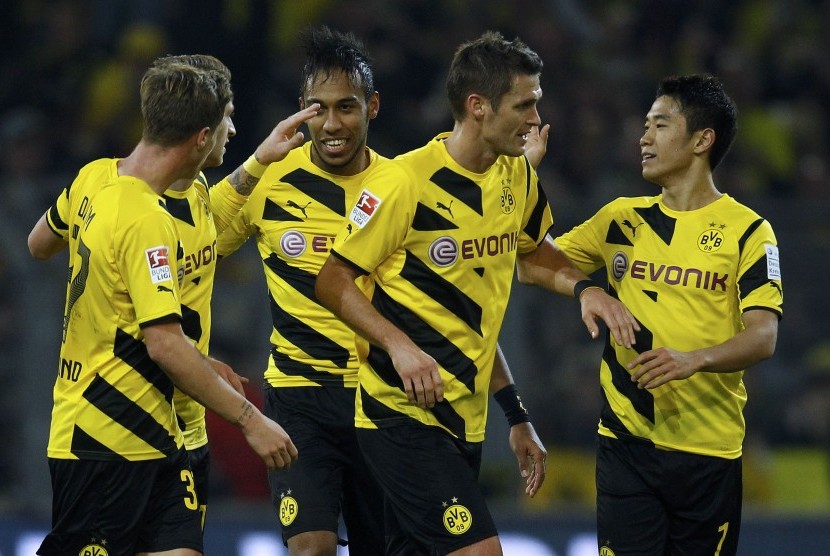 Borussia Dortmund players celebrate an owngoal by Borussia Moenchengladbach during the Bundesliga first division soccer match in Dortmund November 9, 2014