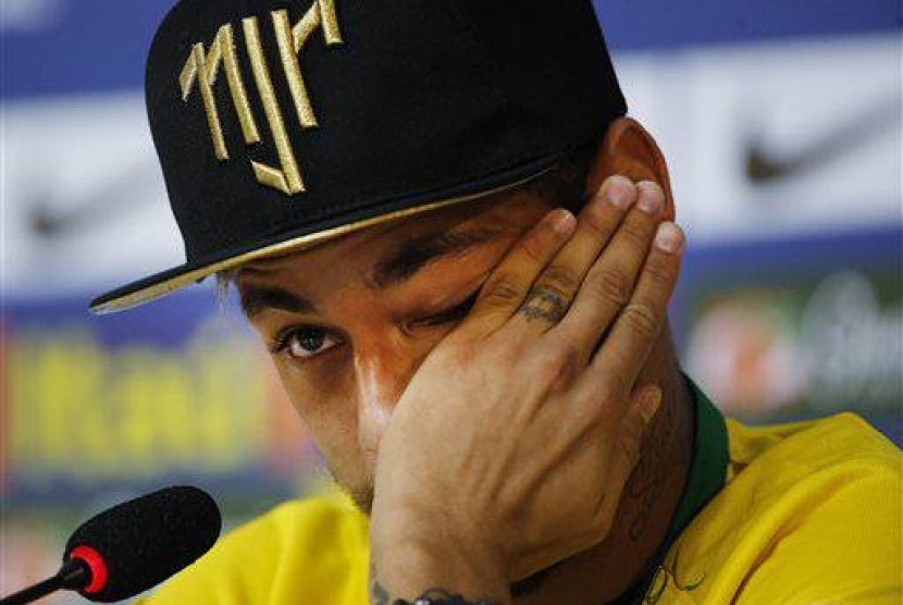 Brazil's Neymar wipes a tear during a press conference at the Granja Comary training center in Teresopolis, Brazil, Thursday, July 10, 2014. 