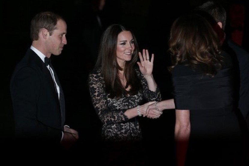 Britain's Duke of Cambridge Prince William (left) and Kate Middleton the Duchess of Cambridge (center) arrive at the Natural History Museum in London, on Dec. 11, 2013. 