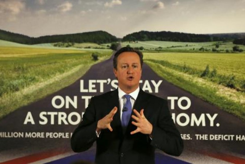 Britain's Prime Minister David Cameron speaks as he stands in front of a new Conservative Party poster, after unveiling it at Dean Clough Mill in Halifax, northern England January 2, 2015.