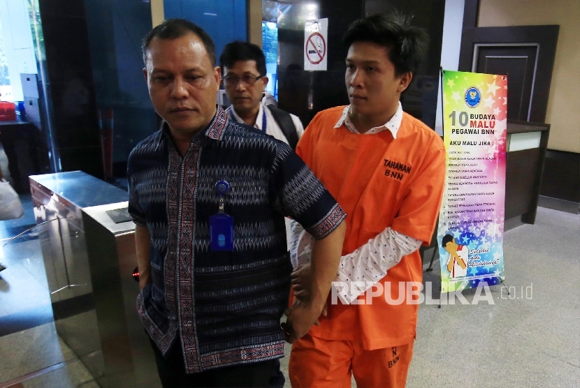 Bupati Ogan Ilir Ahmad Wazir Nofiadi Mawardi dikawal petugas BNN untuk dibawa ke Pusat Rehabilitasi BNN Lido, Jakarta, Jumat (18/3). (Republika/Yasin Habibi)