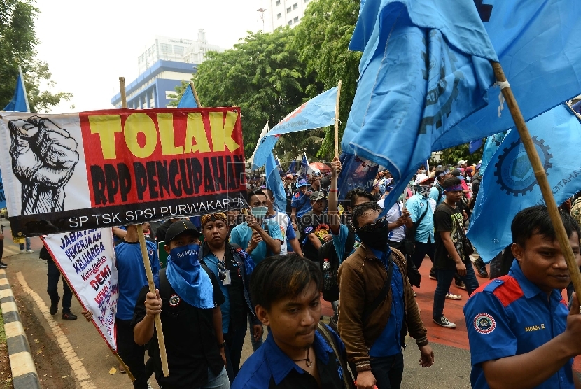   Buruh yang tergabung dalam Serikat Pekerja Seluruh Indonesia (SPSI) melakukan aksi unjuk rasa di depan Istana Negara, Jakarta, Rabu (28/10).   (Republika/Raisan Al Farisi)