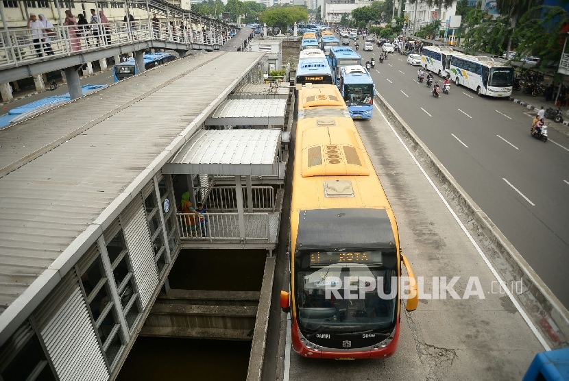 Bus transjakarta menurunkan dan mengakut penumpang saat berada di Halte Harmoni, Jakarta, Rabu (4/11).