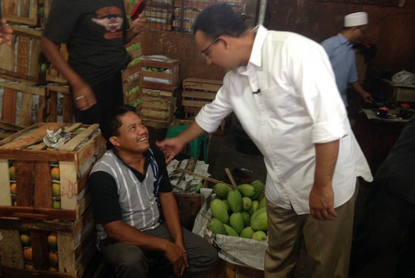 Cagub DKI, Anies Baswedan mendengar keluhan pedagang mangga di Pasar Kramat Jati, Rabu (8/2).