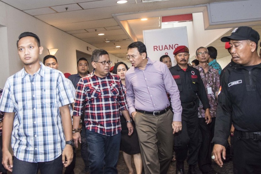 Cagub DKI Jakarta Basuki Tjahaja Purnama alias Ahok (ketiga kiri) bersama Sekjen PDIP Hasto Kristiyanto (kedua kiri) meninggalkan ruangan usai memberikan arahan saat pelatihan saksi-saksi PDIP di Kemayoran, Jakarta, Minggu (9/4).