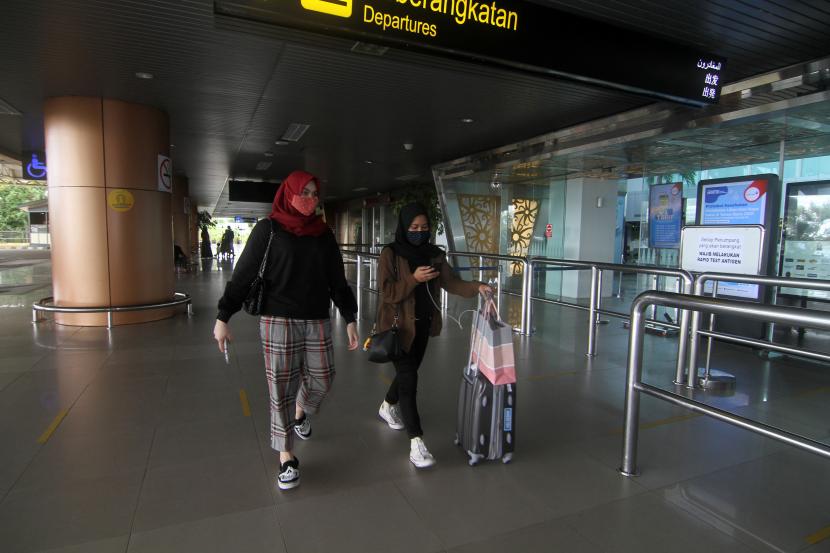 Calon penumpang berjalan di terminal keberangkatan di Bandara Supadio, Kabupaten Kubu Raya, Kalimantan Barat. Pemerintah memperpanjang pemberlakuan aturan tentang protokol kesehatan (prokes) kedatangan orang dari luar negeri ke dalam negeri selama pandemi Covid-19. 