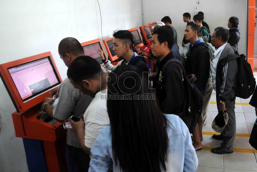 Calon penumpang kereta mencetak tiket mandiri di Stasiun Senen, Jakarta, Selasa (1/9).   (Republika/Agung Supriyanto)