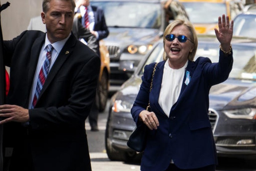 Calon presiden AS Hillary Clinton melambaikan tangan saat keluar dari apartemen putrinya, Ahad (11/9) di New York. Sebelumnya dia meninggakan peringatan 9/11 lebih awal.