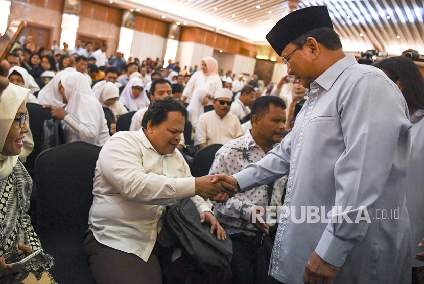 Calon Presiden nomor urut 02 Prabowo Subianto (kanan) menyalami penyandang disabilitas saat menghadiri peringatan Hari Disabilitas Internasional di Jakarta, Rabu (5/12/2018). 