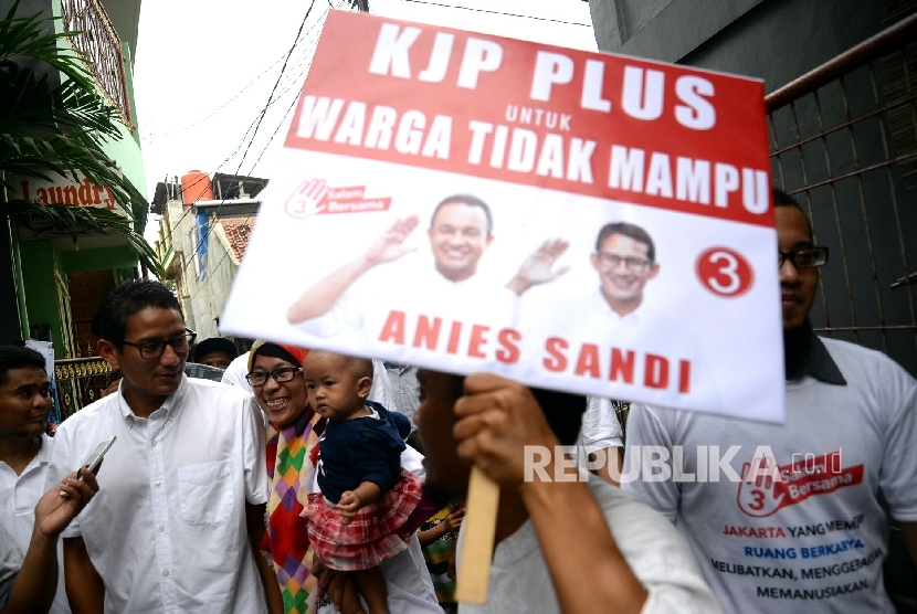 Calon Wakil Gubernur DKI Jakarta Sandiaga S. Uno menyapa warga saat kampanye di Kampung Dukuh, Kramat Jati, Jakarta, Kamis (24/11).