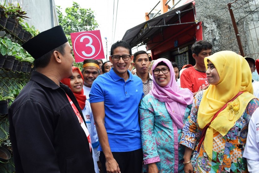 Calon Wakil Gubernur DKI Jakarta Sandiaga Uno (kedua kiri) menyapa warga saat mengunjungi kelurahan Mampang, Jakarta, Rabu (17/1).