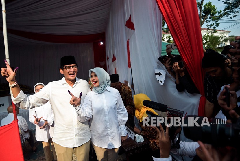 Calon Wakil Presiden nomor urut 02 Sandiaga Uno (kiri) dan istri Nur Asia Uno (kanan menunjukkan jari yang telah dicelup tinta usai melakukan pencoblosan dalam Pemilu 2019 di TPS 02, Jakarta, Rabu (17/4/2019).