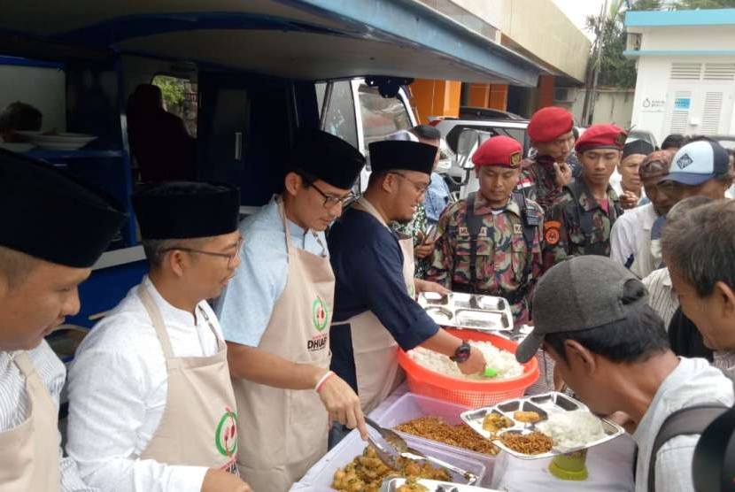 Calon Wakil Presiden Sandiaga Solahudin Uno menjadi pelayan sementara di Waroeng Makan Dhuafa Pemuda Muhammadiyah untuk melayani makan siang jamaah Shalat Jumat di Kantor Pusat Dakwah Muhammadiyah, Jumat (14/9).