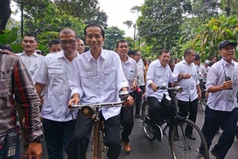 Capres dari PDIP Joko Widodo (ketiga kiri) bersepeda bersama cawapresnya Jusuf Kalla dari kediaman Ketum PDIP Megawati Soekarnoputri di Menteng, menuju gedung Komisi Pemilihan Umum (KPU), Jakarta Pusat, Senin (19/5). 