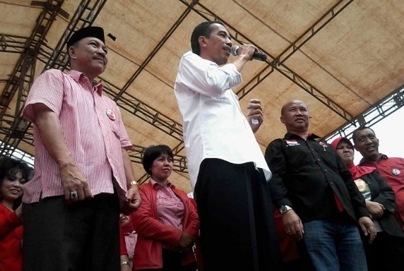 Capres PDI-Perjuangan Joko Widodo (tengah) didampingi Cagub-cawagub Lampung Berlian Tihang (kanan) dan Mukhlis Basri (kiri) saat orasi politik pada kampanye terbuka di Lapangan Rejo Basuki, Seputih Raman, Lampung Tengah, Sabtu (22/3).