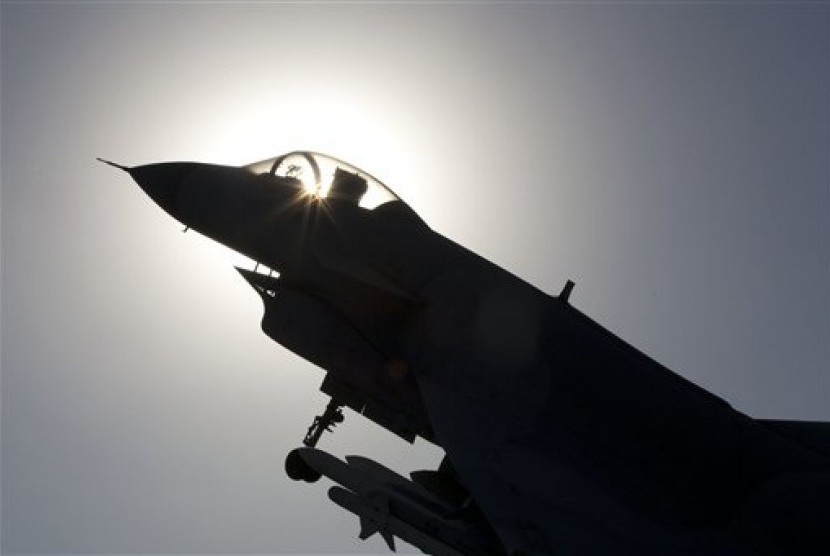 The replica of a Chinese made fighter jet is silhouetted against the sun in Beijing, China, Wednesday, Nov. 27, 2013. China said it had monitored two unarmed US bombers flew over the East China Sea.
