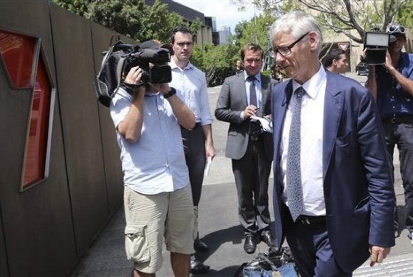 Chief Legal and Commercial Director of Seven Network Bruce Ian McWilliam (front right) arrives to speak to the media after Australian Federal Police raided their headquarters in Sydney, Australia, Tuesday, Feb. 18, 2014. 