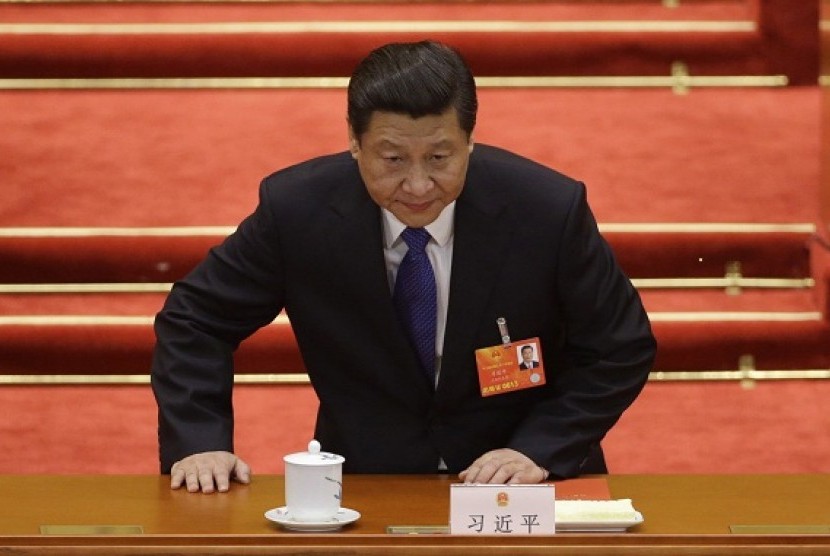 China's newly-elected President Xi Jinping takes a seat before the fifth plenary meeting of the National People's Congress (NPC) at theGreat Hall of the People in Beijing, March 15, 2013.