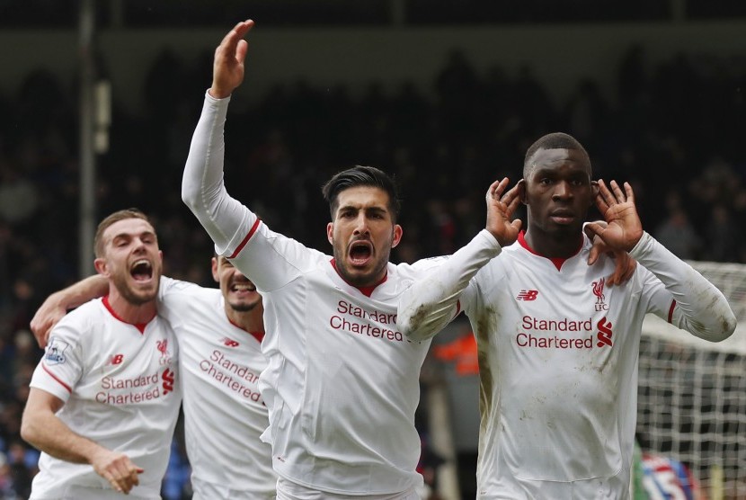 Christian Benteke celebrates with team mates after scoring the second goal for Liverpool